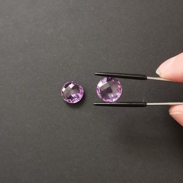 A photo of the crown area of the purple amethysts against a black background