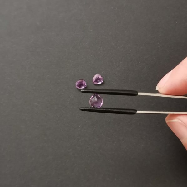 a photo of the pavilion of the purple amethyst hearts against a black background