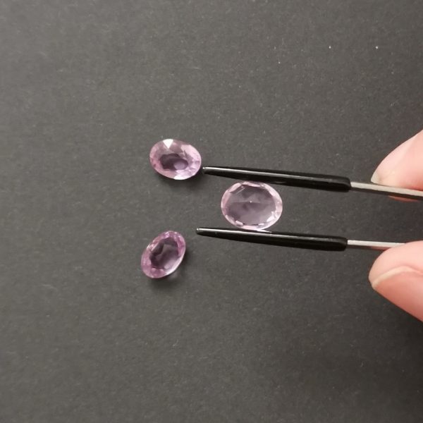a photo of the pavilion of the purple amethyst ovals against a black background