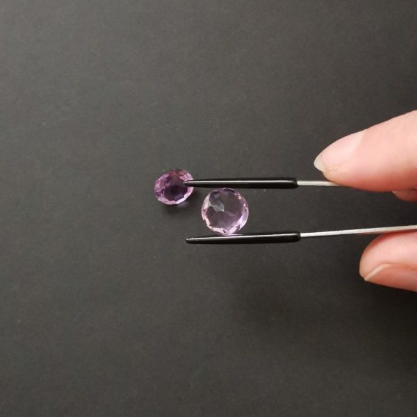 a photo of the pavilion of the purple amethyst rounds against a black background