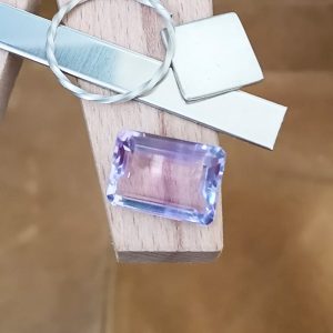 The purple amethyst rectangle displayed on a jewellers bench peg with some sterling silver sheet and wire.