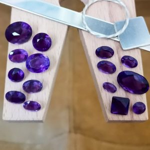 The purple amethysts are displayed on a jewellers bench peg with some sterling silver sheet and wire.
