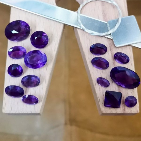 The purple amethysts are displayed on a jewellers bench peg with some sterling silver sheet and wire.
