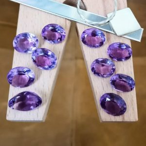 The purple amethyst oval bundle displayed on a jewellers bench peg with some sterling silver sheet and wire.