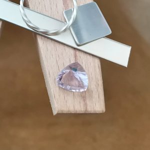 The lavender amethyst displayed on a jewellers bench peg with some sterling silver sheet and wire.