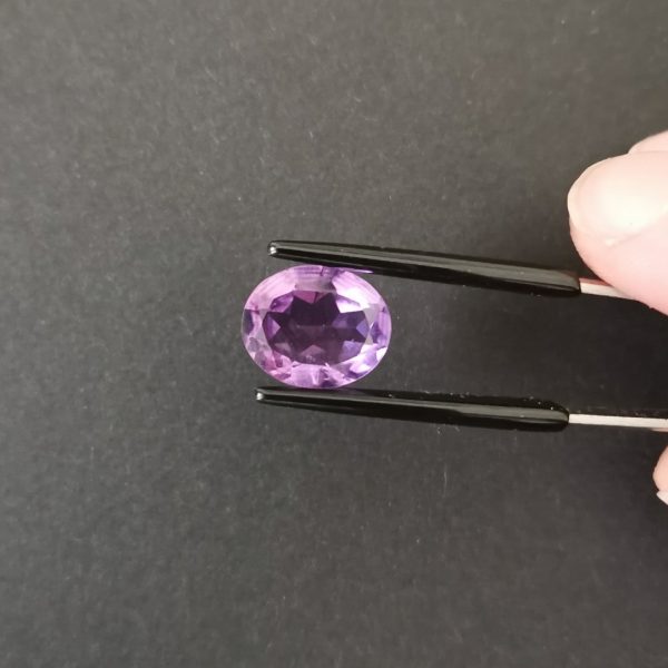 A photo of the crown area of the purple amethyst against a black background