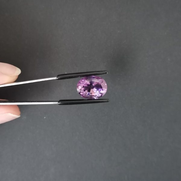 A photo of the crown area of the purple amethyst against a black background