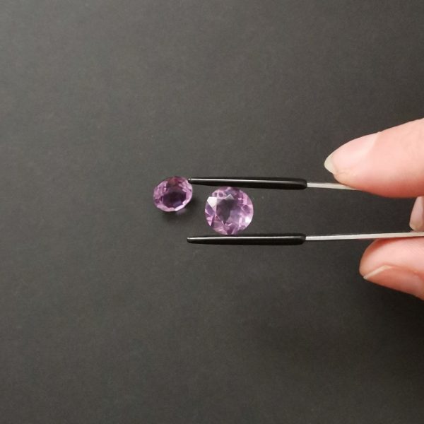 A photo of the crown area of the purple amethysts against a black background