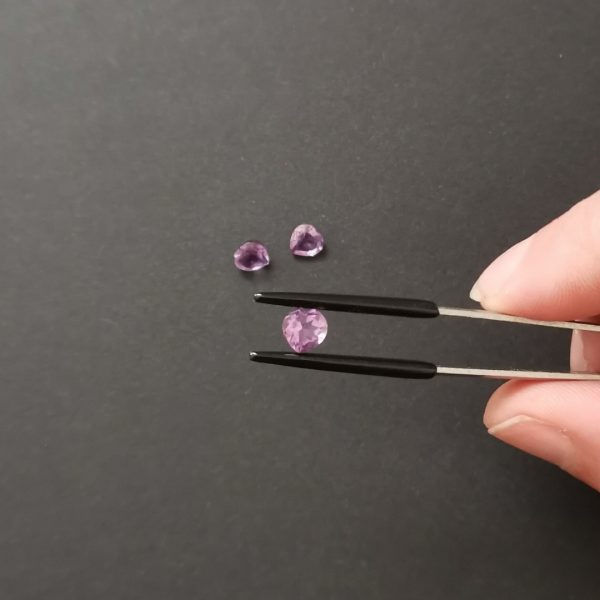 A photo of the crown area of the purple amethysts against a black background