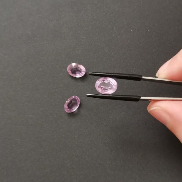 A photo of the crown area of the purple amethysts against a black background