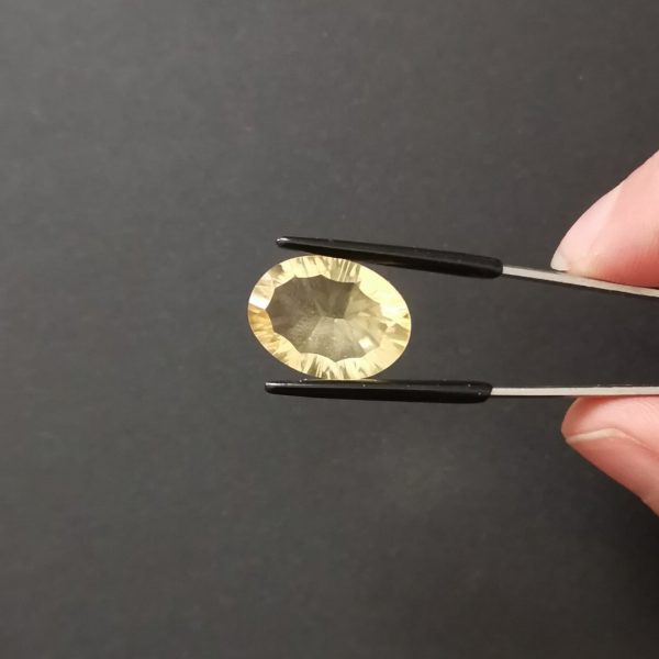 A photo of the crown area of the golden yellow citrine against a black background