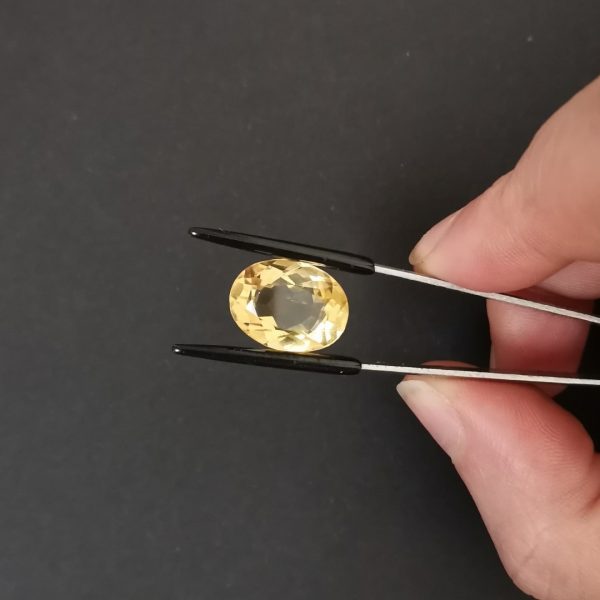 A photo of the crown area of the golden yellow citrine against a black background