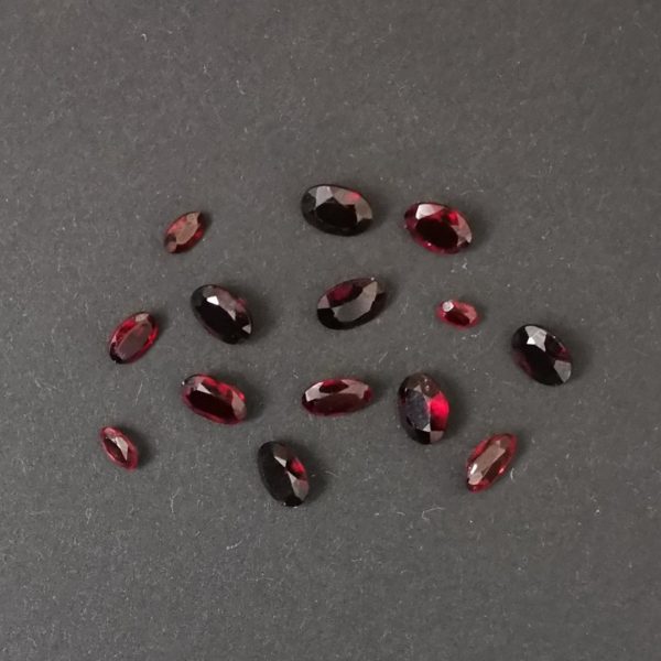 A photo of the red garnet ovals displayed on a black background.