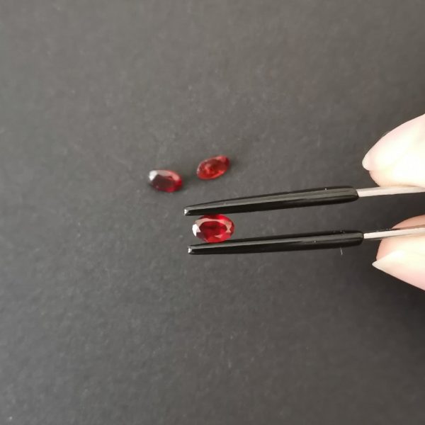 A photo of the crown area of the red garnets against a black background