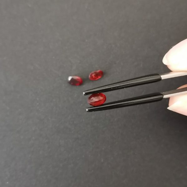 a photo of the pavilion of the red garnet ovals against a black background