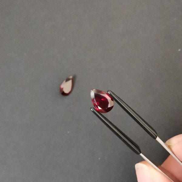 A photo of the crown area of the red garnets against a black background