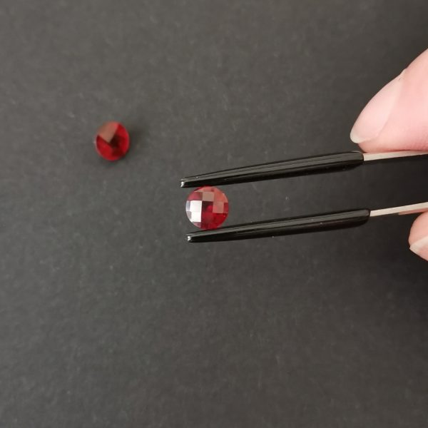 A photo of the crown area of the red garnets against a black background