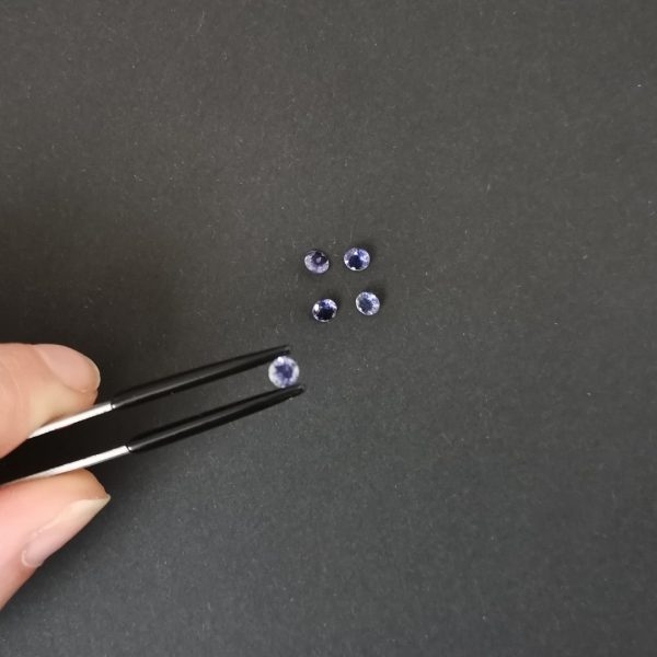 A photo of the crown area of the violet-blue iolite against a black background