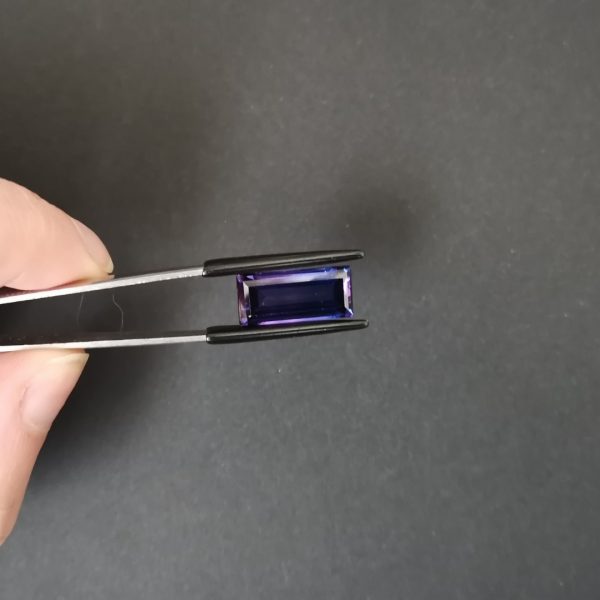 A photo of the crown area of the purple lab grown sapphire against a black background