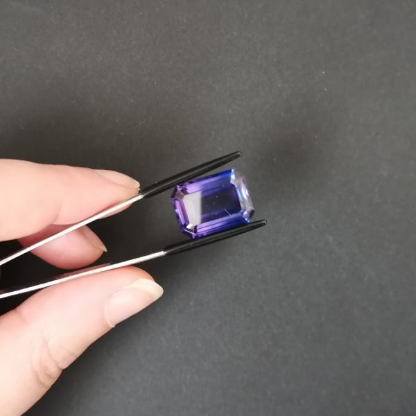 A photo of the crown area of the purple lab grown sapphire against a black background