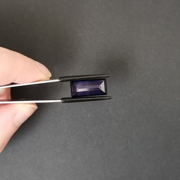 photo of the pavilion of the lab grown purple sapphire rectangle against a black background
