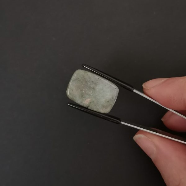a photo of the bottom of the labradorite cabochon against a black background