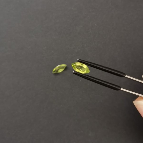 A photo of the crown area of the green peridots against a black background