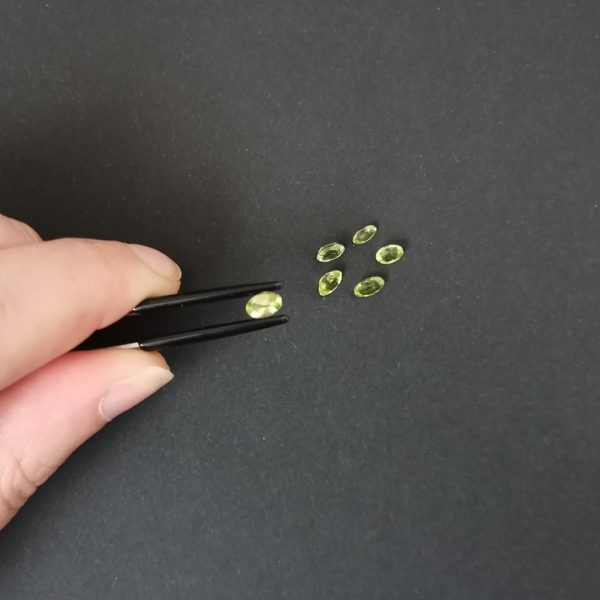 A photo of the crown area of the green peridots against a black background