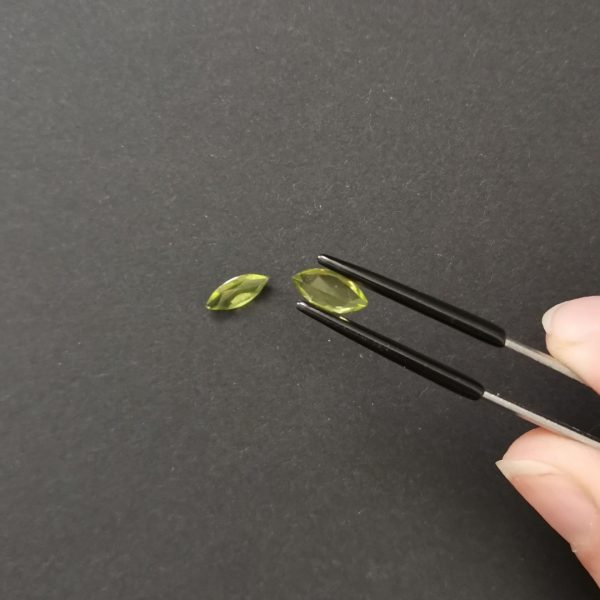 a photo of the pavilion of the lime green peridot marquises against a black background