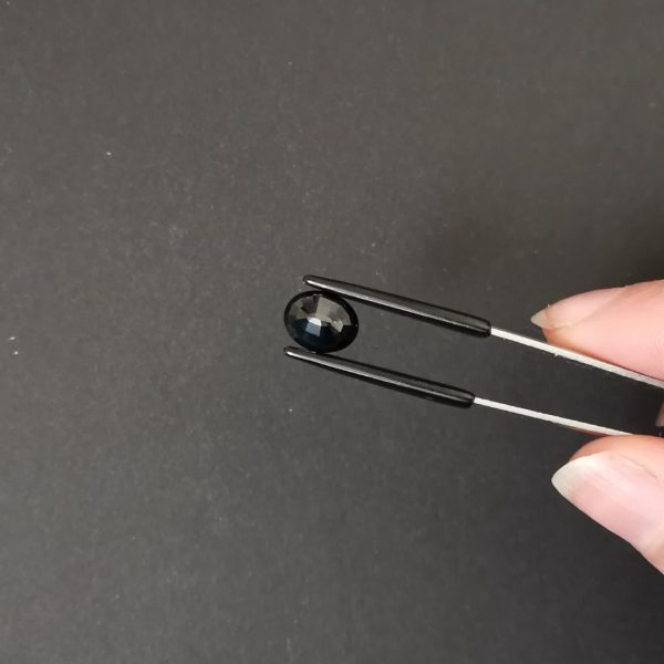 a photo of the pavilion of the highly saturated blue sapphire oval against a black background