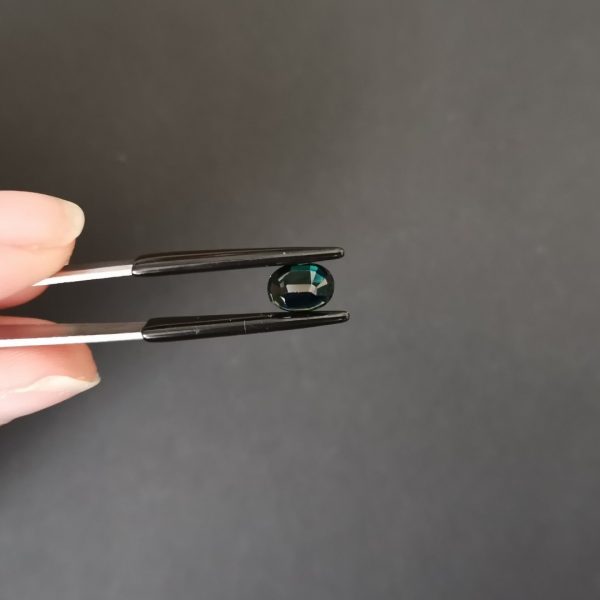 a photo of the pavilion of the bi coloured sapphire oval against a black background