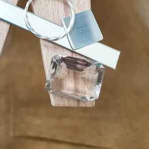 The Smoky Quartz displayed on a jewellers bench peg with some sterling silver sheet and wire.