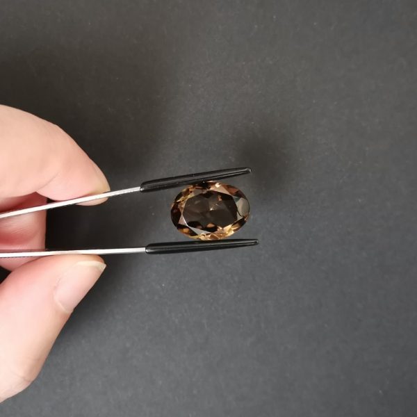 A photo of the crown area of the brown smoky quartz against a black background