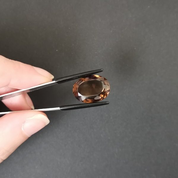 A photo of the crown area of the warm brown smoky quartz against a black background