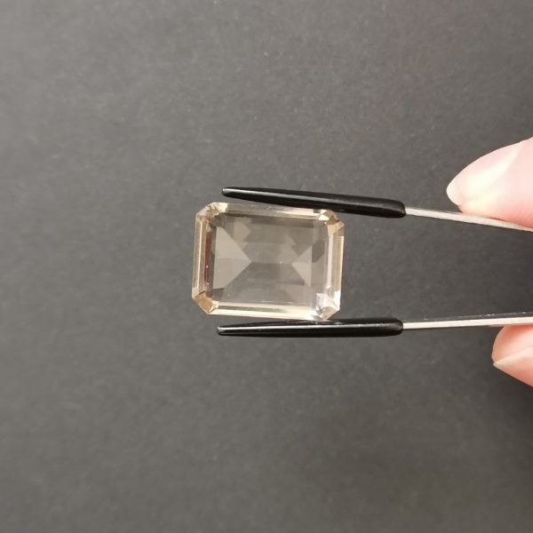 a photo of the pavilion of the brown smoky quartz rectangle against a black background