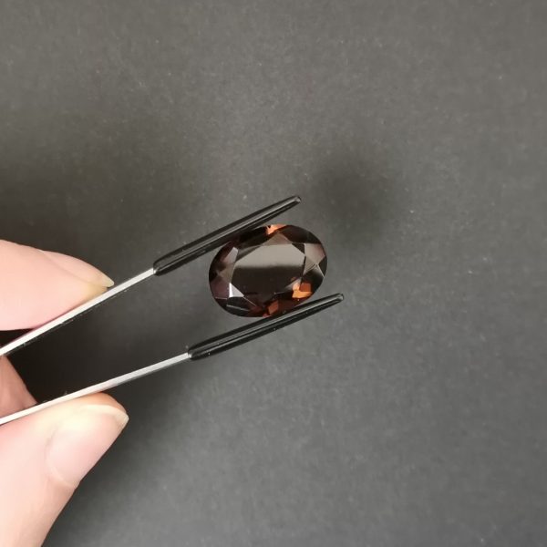 A photo of the crown area of the brown smoky quartz against a black background