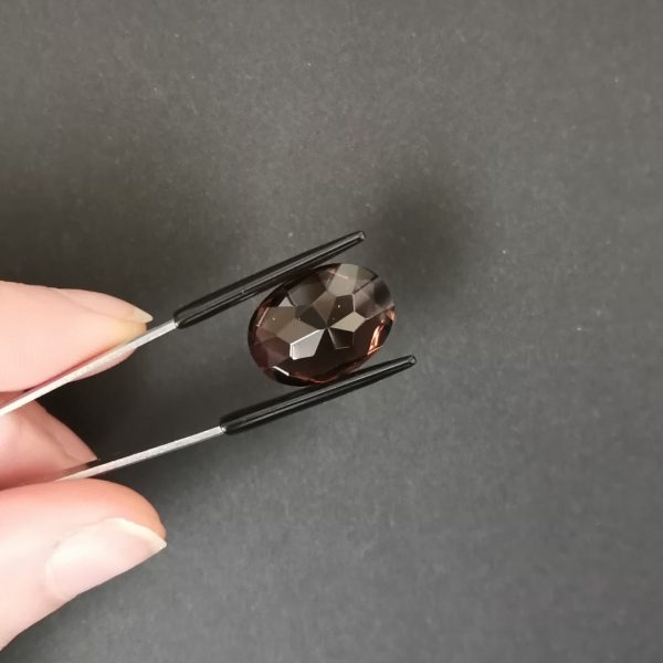 photo of the pavilion of the brown smoky quartz oval against a black background