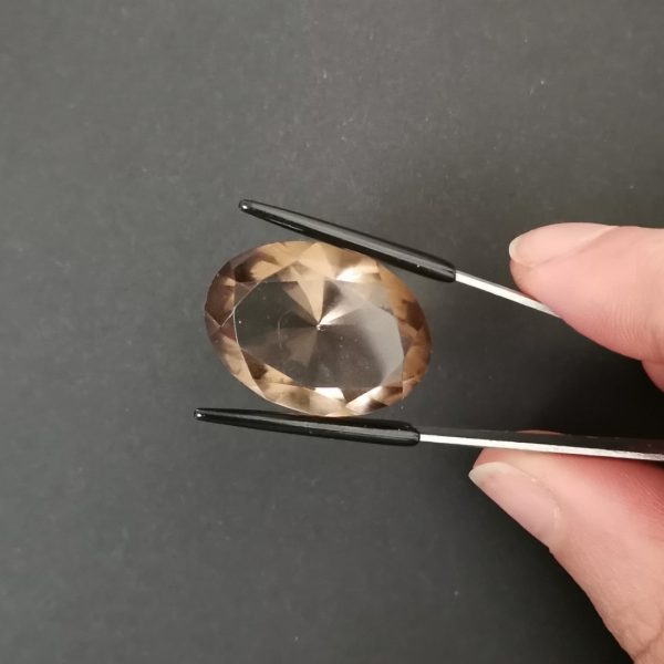 A photo of the crown area of the brown smoky quartz against a black background