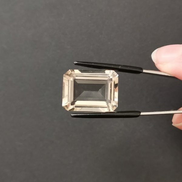 A photo of the crown area of the pale brown smoky quartz against a black background