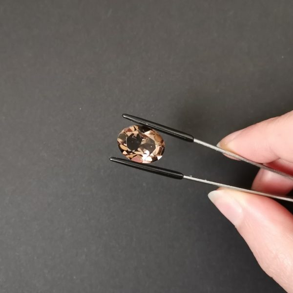 A photo of the crown area of the brown smoky quartz against a black background