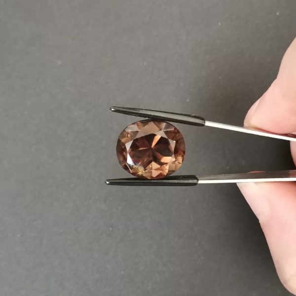 A photo of the crown area of the brown smoky quartz against a black background