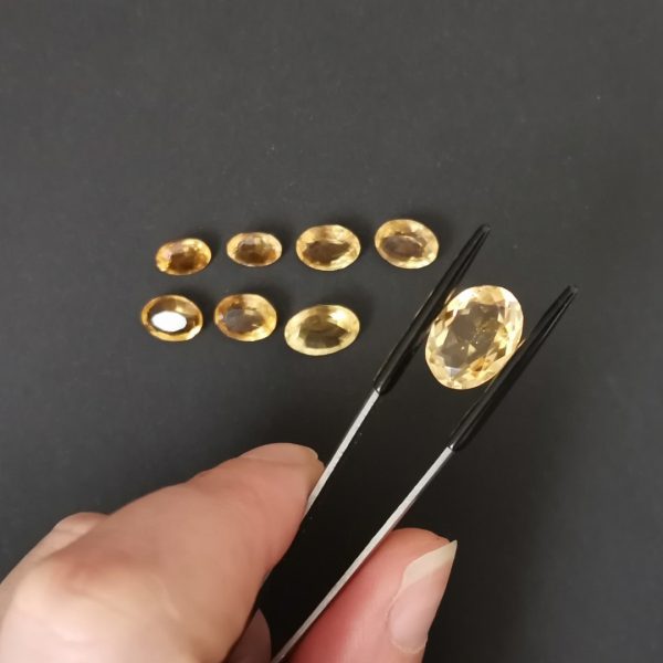 A photo of the crown area of the golden yellow citrines against a black background