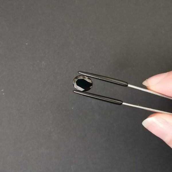 A photo of the crown area of the deep blue sapphire against a black background
