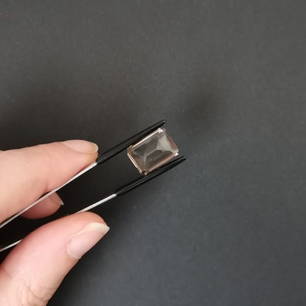 a photo of the pavilion of the brown smoky quartz rectangle against a black background