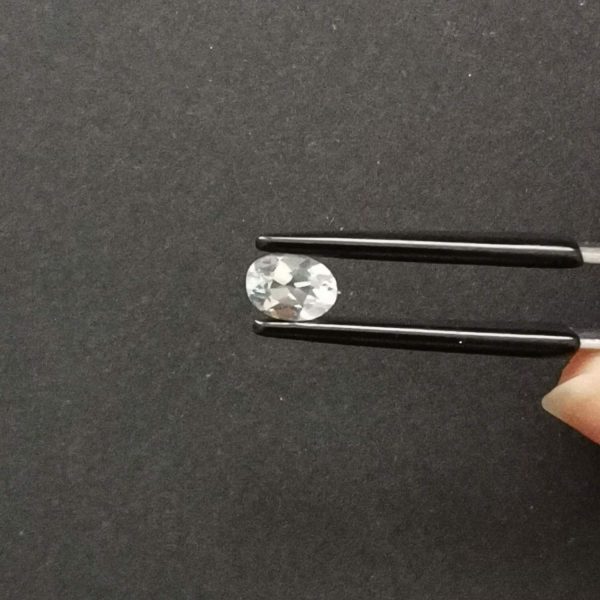 A photo of the crown area of the pale blue aquamarine against a black background