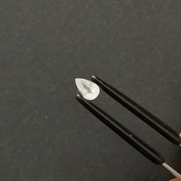 A photo of the crown area of the white moonstone against a black background