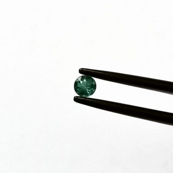 A photo of the crown area of the green tourmaline against a white background