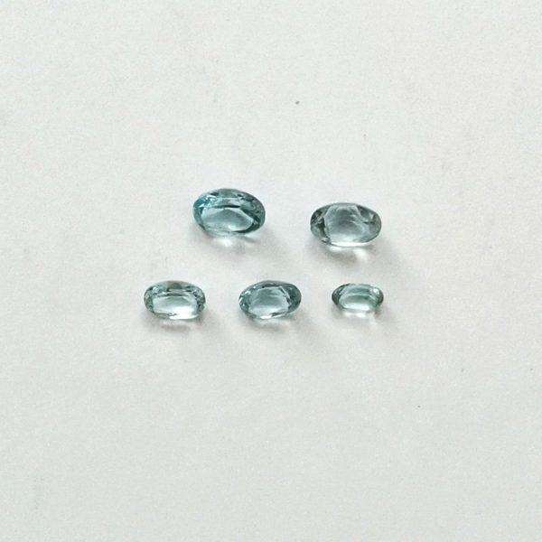 The 5 sky blue topaz ovals displayed on a white background
