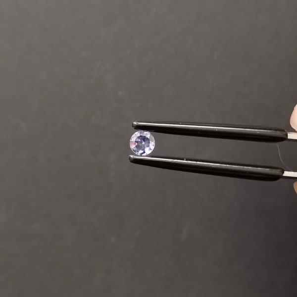 A photo of the crown area of the pale violet tanzanite against a black background