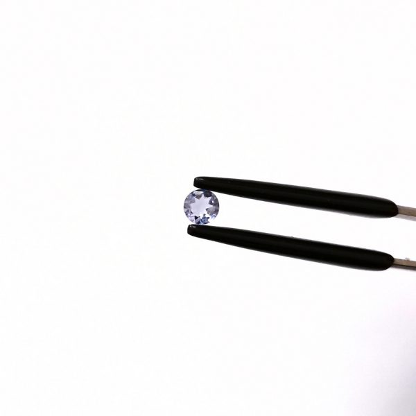 A photo of the crown area of the light violet tanzanite against a black background